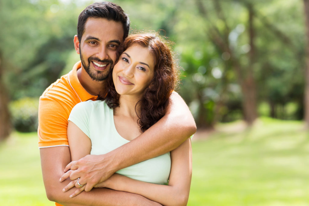 Smiling couple who receive family dentistry services at McQueen Dental ini Fayetteville, AR to keep there smiles healthy. 