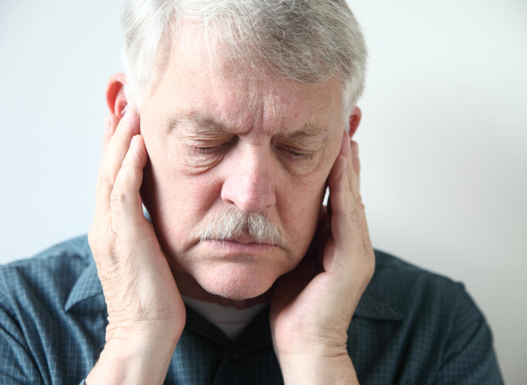 Man with ear pain may be suffering from TMJ.